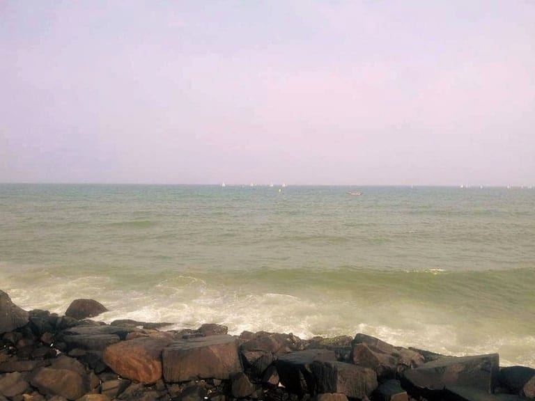 a Rock beach with waves crashing upon the shore.