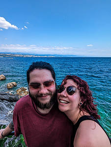 Lisa and I standing in front of the seaside with the town of Rijeka far in the background