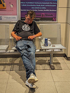 An Austrian Alcoholic Asleep drunk and asleep at a local train station in the middle of the day. Showing just how inseparable Austria and alcohol are.